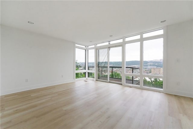 2613 Stella St, South Side, PA 15203 - unfurnished room featuring expansive windows, light wood-style flooring, and a city view