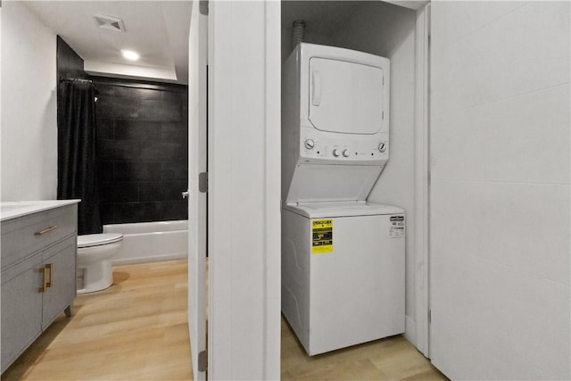 2613 Stella St, South Side, PA 15203 - washroom with stacked washing machine and dryer, recessed lighting, and light wood finished floors