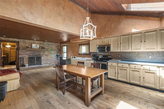 1345 N Tower Rd, Perry Twp, PA 16123 - dining room featuring wooden ceiling, light wood finished floors, a towering ceiling, a brick fireplace, and a chandelier