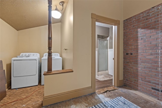 1345 N Tower Rd, Perry Twp, PA 16123 - washroom with washer and clothes dryer, a textured ceiling, and brick wall