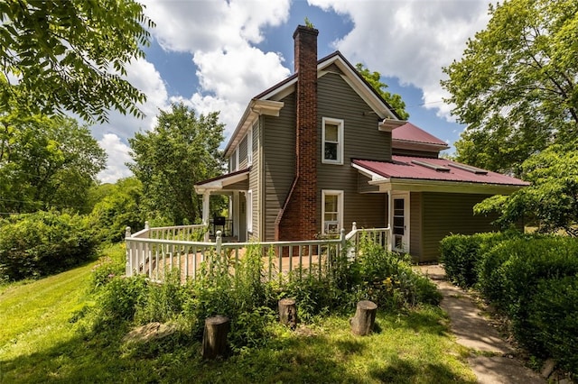 1345 N Tower Rd, Perry Twp, PA 16123 - rear view of property featuring a chimney, a wooden deck, and a metal roof