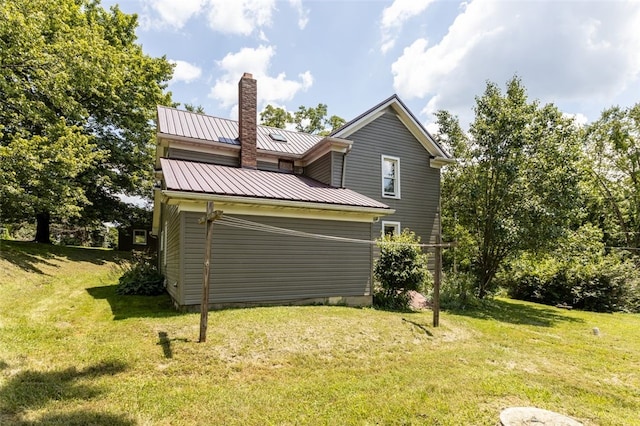 1345 N Tower Rd, Perry Twp, PA 16123 - rear view of property with a chimney, a yard, a metal roof, and a standing seam roof