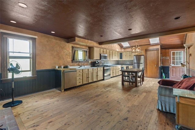 1345 N Tower Rd, Perry Twp, PA 16123 - kitchen featuring stainless steel appliances, light wood-style floors, wainscoting, a chandelier, and pendant lighting