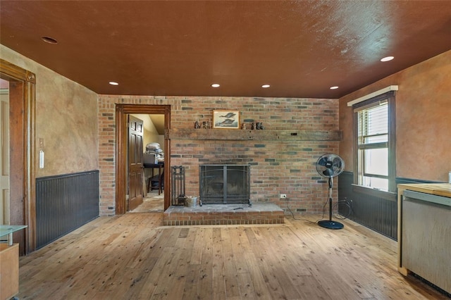 1345 N Tower Rd, Perry Twp, PA 16123 - unfurnished living room with a brick fireplace, hardwood / wood-style floors, wainscoting, and recessed lighting