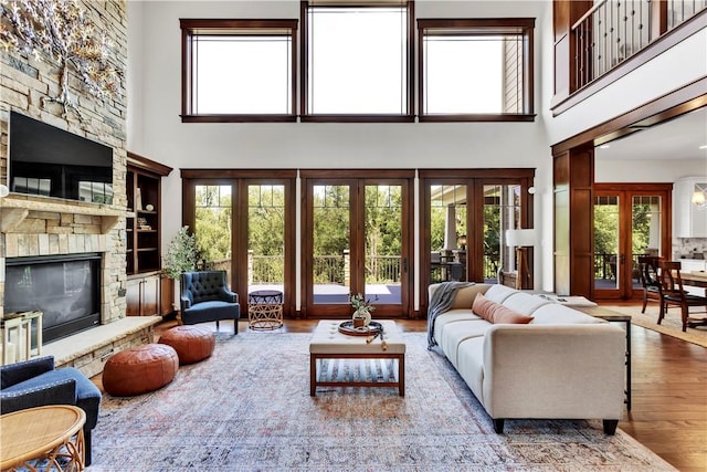 106 Orchard Dr, Pine Twp, PA 15044 - living room featuring french doors, a fireplace, wood finished floors, a high ceiling, and built in features