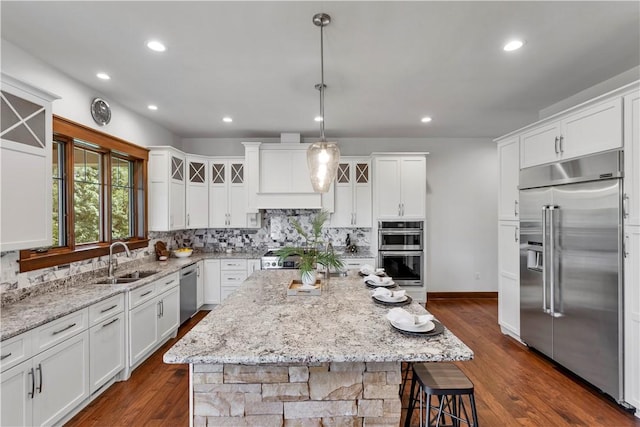 106 Orchard Dr, Pine Twp, PA 15044 - kitchen featuring appliances with stainless steel finishes, decorative backsplash, white cabinets, a center island, and recessed lighting