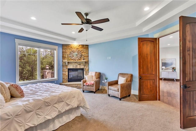 106 Orchard Dr, Pine Twp, PA 15044 - bedroom with a tray ceiling, recessed lighting, carpet floors, a stone fireplace, and a ceiling fan