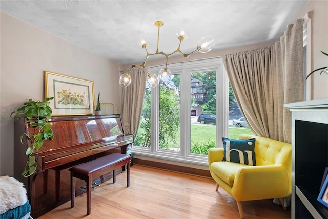 5671 Beacon St, Squirrel Hill, PA 15217 - sitting room featuring a chandelier, light wood-style flooring, and a fireplace