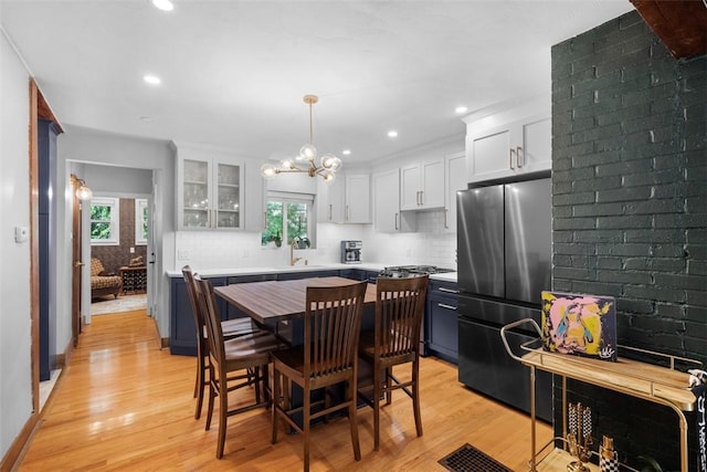 5671 Beacon St, Squirrel Hill, PA 15217 - dining area featuring plenty of natural light, a chandelier, light wood-type flooring, and recessed lighting