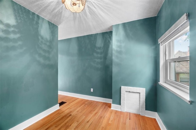 5671 Beacon St, Squirrel Hill, PA 15217 - spare room featuring wood finished floors and a chandelier