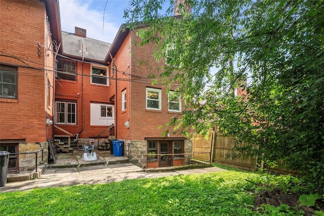 5671 Beacon St, Squirrel Hill, PA 15217 - back of property featuring brick siding, entry steps, and a patio