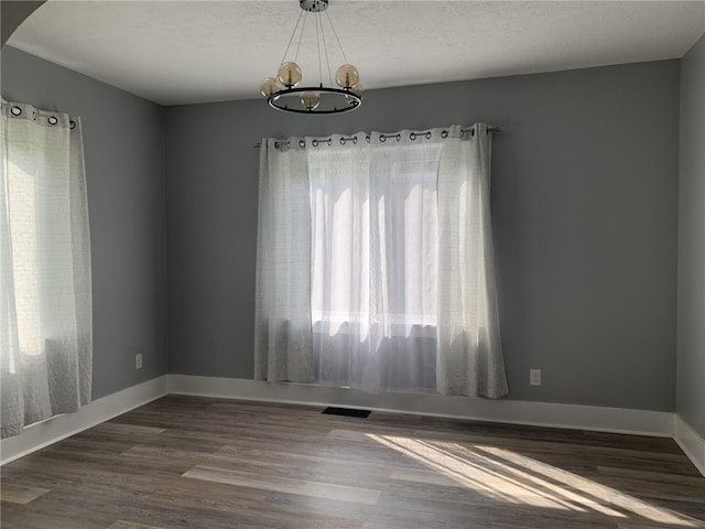 1101 State Route 356, Allegheny Twp, PA 15656 - spare room with a chandelier, dark wood finished floors, and a textured ceiling