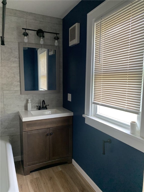 1101 State Route 356, Allegheny Twp, PA 15656 - full bath featuring wood finished floors, vanity, and a tub