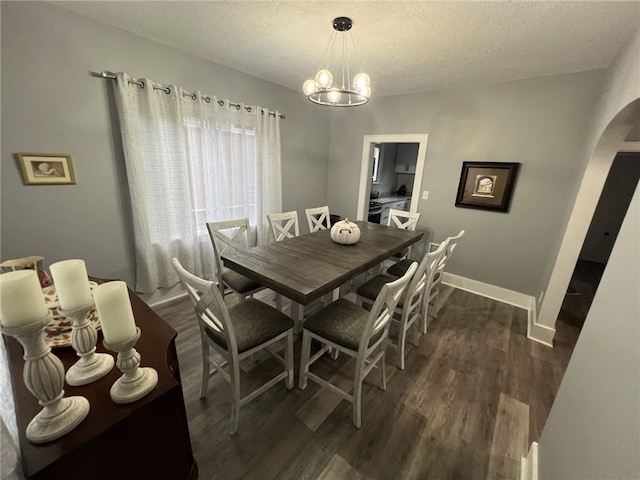 1101 State Route 356, Allegheny Twp, PA 15656 - dining area with arched walkways, dark wood-style flooring, a textured ceiling, and a chandelier