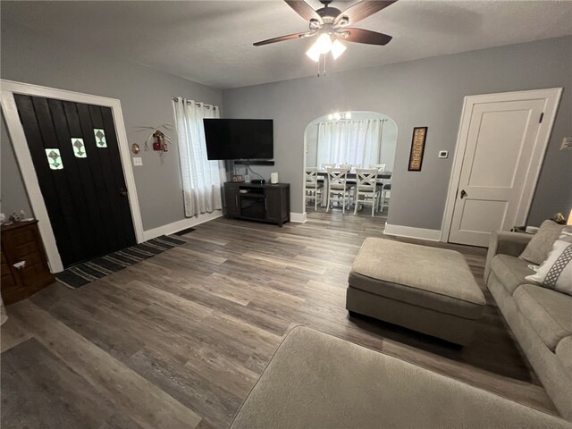1101 State Route 356, Allegheny Twp, PA 15656 - living room with arched walkways, ceiling fan, and wood finished floors