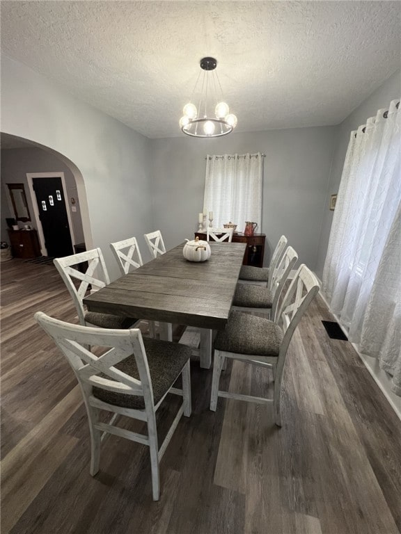 1101 State Route 356, Allegheny Twp, PA 15656 - dining space featuring arched walkways, wood finished floors, a textured ceiling, and a chandelier