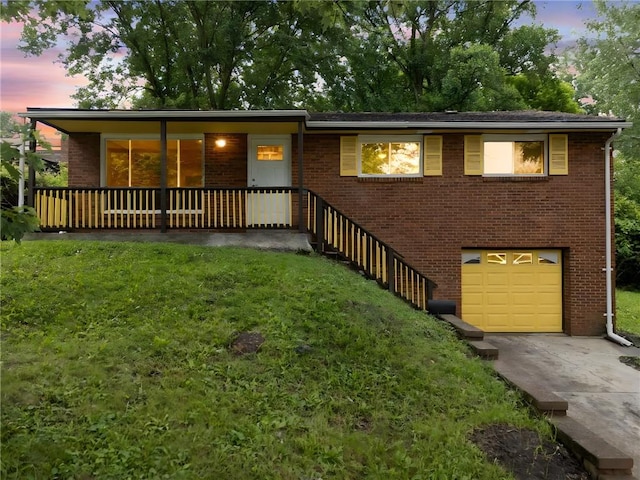 260 Stotler Rd, Penn Hills, PA 15235 - view of front facade with an attached garage, driveway, a front yard, and brick siding