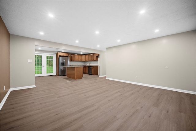 260 Stotler Rd, Penn Hills, PA 15235 - unfurnished living room with light wood-style floors, recessed lighting, and french doors