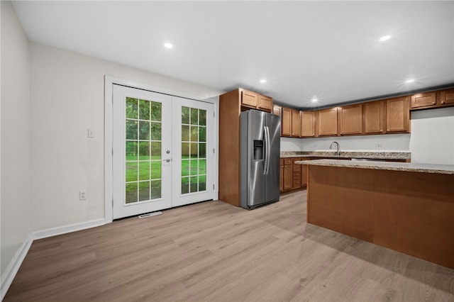 260 Stotler Rd, Penn Hills, PA 15235 - kitchen with stainless steel refrigerator with ice dispenser, light wood finished floors, french doors, recessed lighting, and brown cabinetry