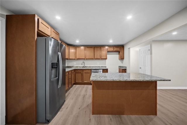 260 Stotler Rd, Penn Hills, PA 15235 - kitchen with appliances with stainless steel finishes, light wood-style floors, recessed lighting, a center island, and light stone counters