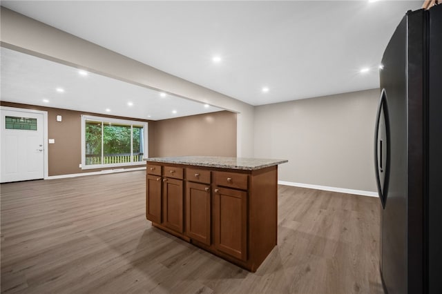 260 Stotler Rd, Penn Hills, PA 15235 - kitchen featuring freestanding refrigerator, light wood finished floors, brown cabinets, a center island, and open floor plan