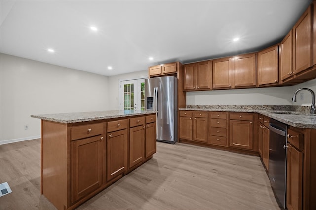 260 Stotler Rd, Penn Hills, PA 15235 - kitchen with stainless steel appliances, light wood-style floors, brown cabinets, light stone countertops, and recessed lighting