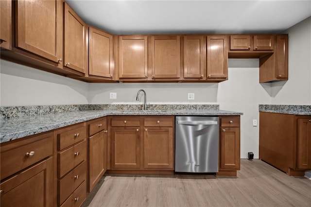 260 Stotler Rd, Penn Hills, PA 15235 - kitchen with stainless steel dishwasher, light wood-style flooring, light stone countertops, and brown cabinetry