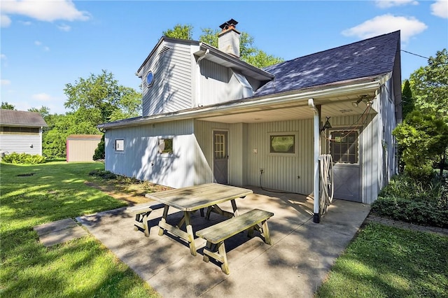 3650 Gibsonia Rd, Richland, PA 15044 - rear view of house featuring a chimney, a patio area, a lawn, and a shingled roof