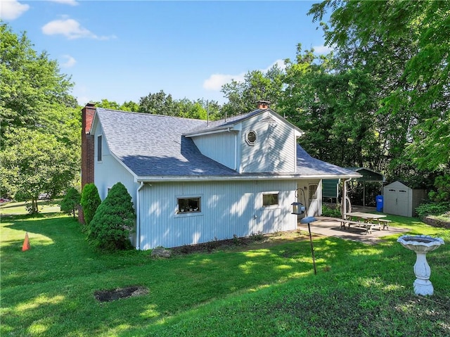 3650 Gibsonia Rd, Richland, PA 15044 - rear view of property featuring a chimney, a shed, a patio, a yard, and roof with shingles