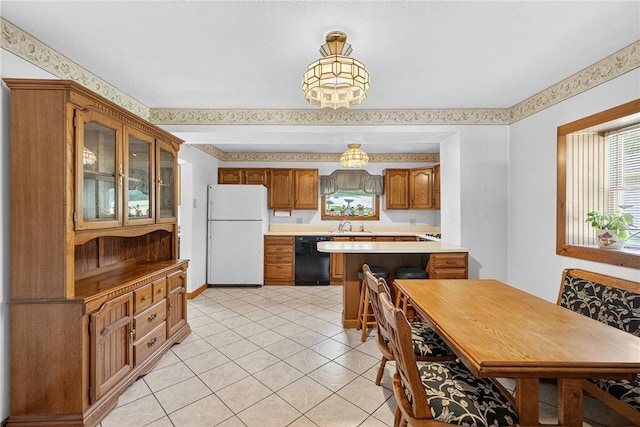 3650 Gibsonia Rd, Richland, PA 15044 - kitchen featuring freestanding refrigerator, black dishwasher, glass insert cabinets, brown cabinets, and light countertops
