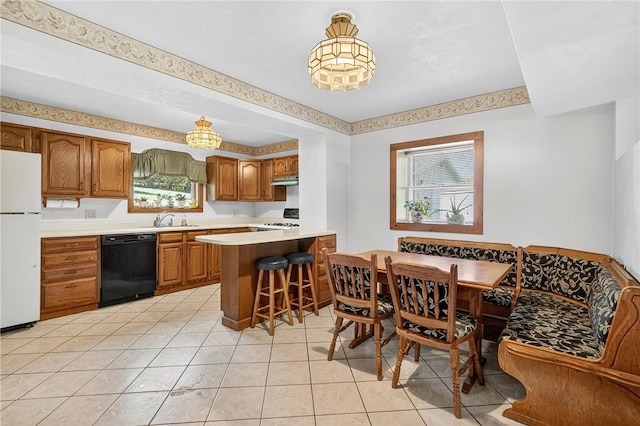 3650 Gibsonia Rd, Richland, PA 15044 - kitchen with black dishwasher, freestanding refrigerator, brown cabinetry, a peninsula, and light countertops