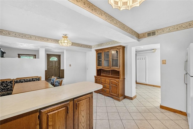 3650 Gibsonia Rd, Richland, PA 15044 - kitchen featuring brown cabinetry, light countertops, light tile patterned floors, and glass insert cabinets