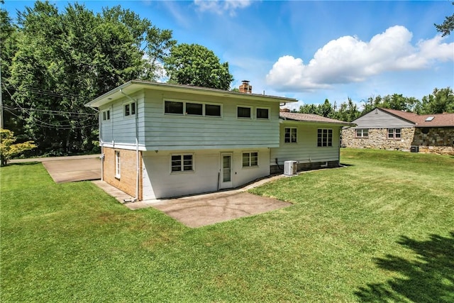 469 Koonce Rd, Hermitage, PA 16148 - back of house with a chimney, a yard, a patio, and brick siding