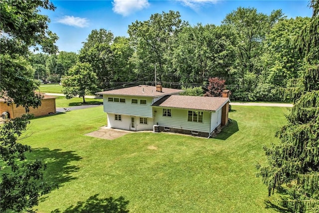 469 Koonce Rd, Hermitage, PA 16148 - rear view of property featuring a chimney, a lawn, and a patio area