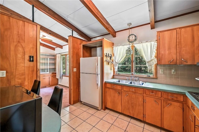 469 Koonce Rd, Hermitage, PA 16148 - kitchen with freestanding refrigerator, brown cabinets, decorative backsplash, light tile patterned flooring, and light countertops