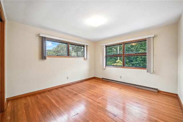 469 Koonce Rd, Hermitage, PA 16148 - empty room with a baseboard heating unit and light wood-style floors