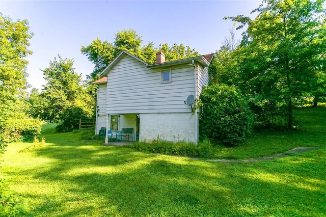 354 Wickhaven Rd, Perry Twp, PA 15492 - view of side of property featuring a chimney and a yard