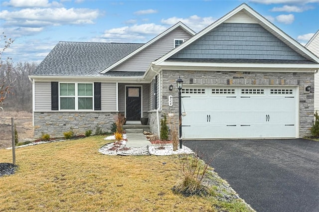 324 Nelson Dr, Monroeville, PA 15146 - craftsman-style home with stone siding, an attached garage, a front lawn, and driveway