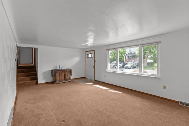 719 12th St, Pitcairn, PA 15140 - unfurnished living room with carpet floors and stairs