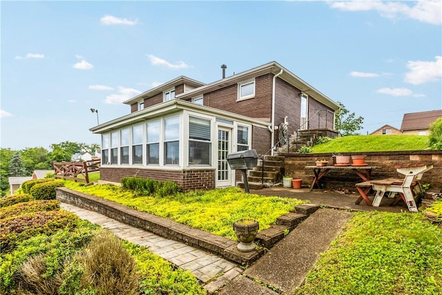 719 12th St, Pitcairn, PA 15140 - rear view of house featuring brick siding and stairs