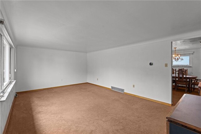 719 12th St, Pitcairn, PA 15140 - unfurnished living room with a chandelier and carpet