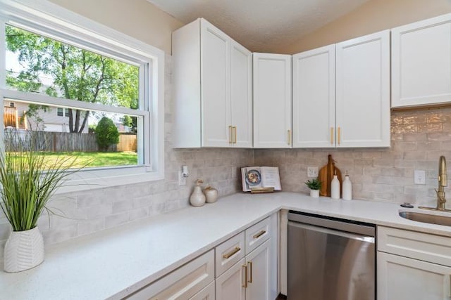 3415 Cedar Glen Dr, West Deer, PA 15101 - kitchen featuring stainless steel dishwasher, tasteful backsplash, white cabinets, light countertops, and lofted ceiling