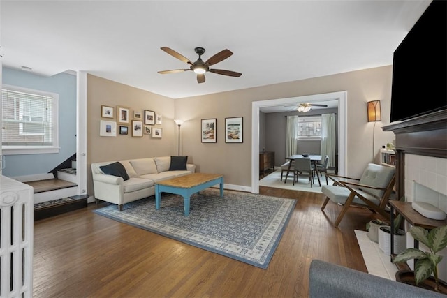210 Ridge Ave, Ben Avon, PA 15202 - living room featuring wood finished floors, a fireplace, a ceiling fan, and stairs