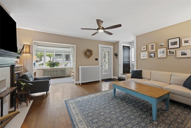 210 Ridge Ave, Ben Avon, PA 15202 - living area with radiator, a ceiling fan, a fireplace, and wood-type flooring