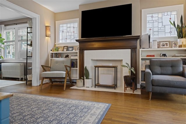 210 Ridge Ave, Ben Avon, PA 15202 - sitting room featuring radiator, wood finished floors, and a tiled fireplace