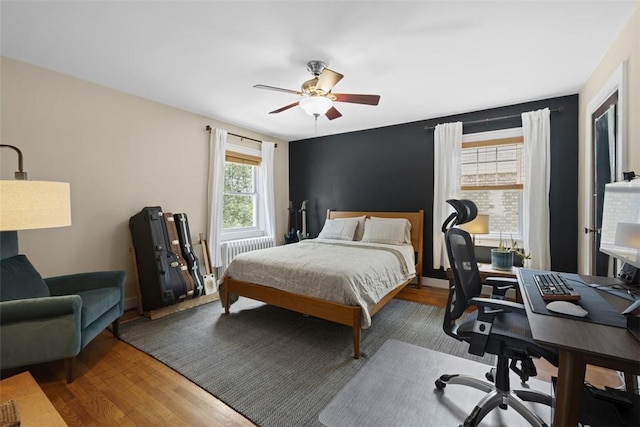 210 Ridge Ave, Ben Avon, PA 15202 - bedroom with radiator heating unit, wood finished floors, a desk, and ceiling fan