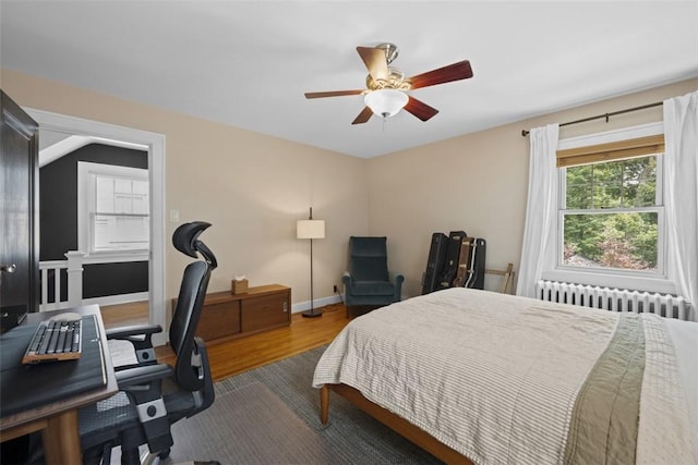 210 Ridge Ave, Ben Avon, PA 15202 - bedroom with radiator heating unit, wood finished floors, a desk, and a ceiling fan