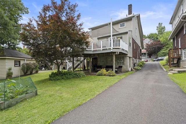 210 Ridge Ave, Ben Avon, PA 15202 - rear view of property with stairs, a wooden deck, a chimney, a yard, and a vegetable garden