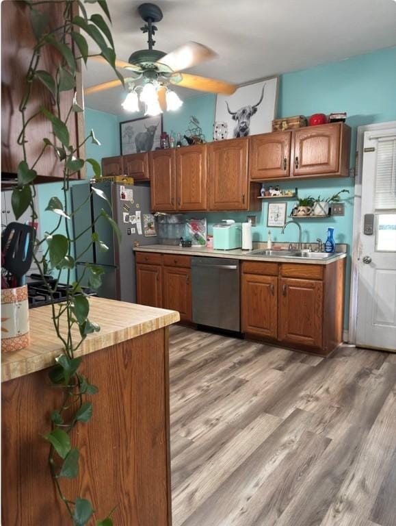 811 Cleveland Ave, Brackenridge, PA 15014 - kitchen featuring dishwasher, brown cabinetry, ceiling fan, and light wood-style flooring