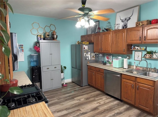 811 Cleveland Ave, Brackenridge, PA 15014 - kitchen with appliances with stainless steel finishes, a ceiling fan, light countertops, and brown cabinets